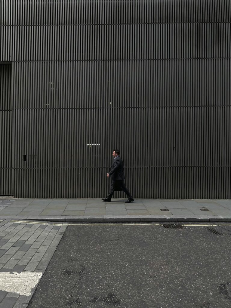 Business professional walking outside a modern office building