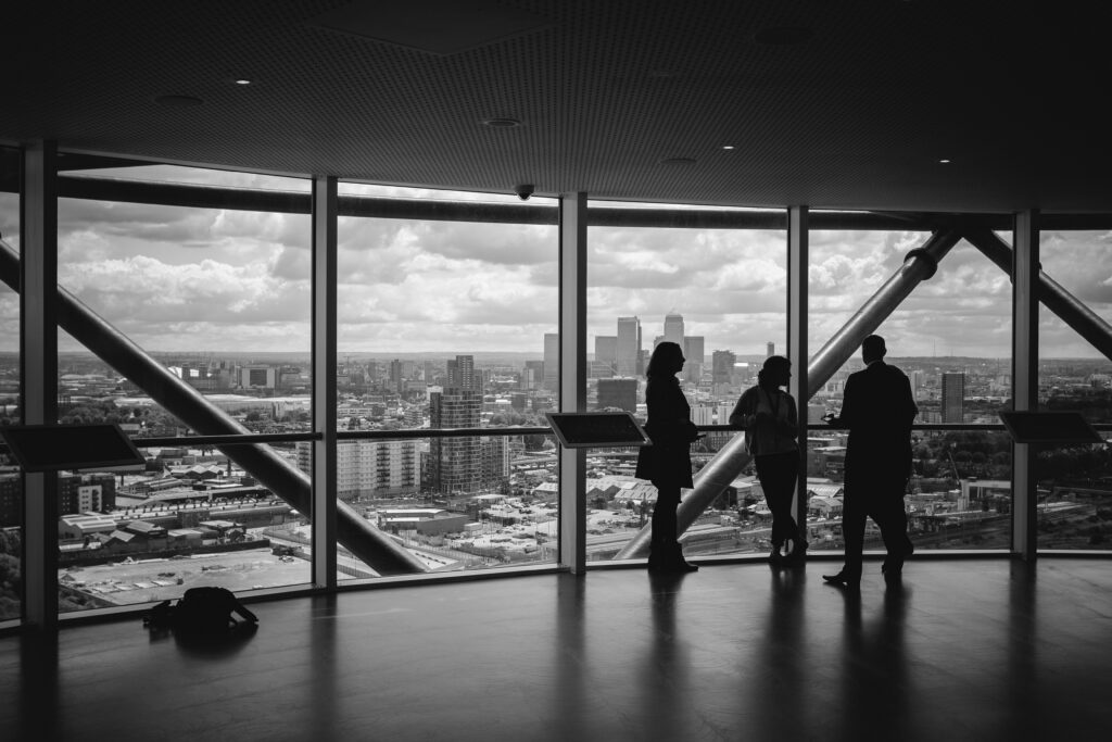 People discussing a legal consultation in an office overlooking a city skyline