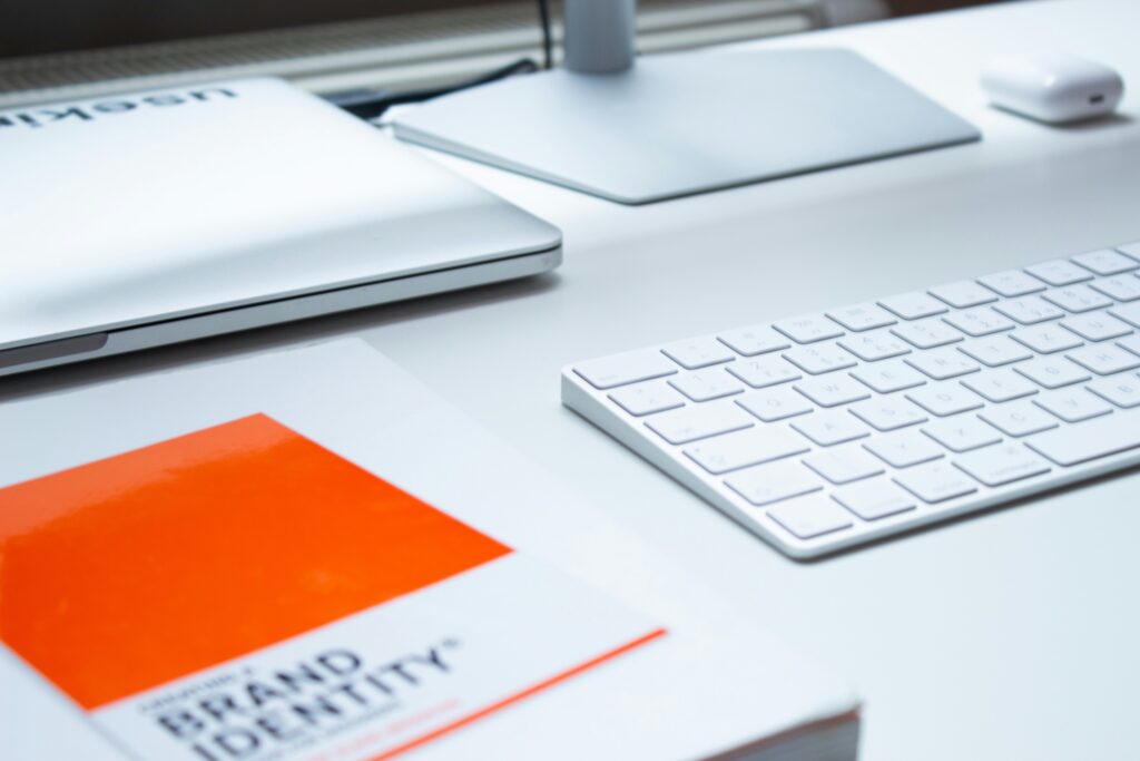 Brand identity document on a desk with keyboard and laptop