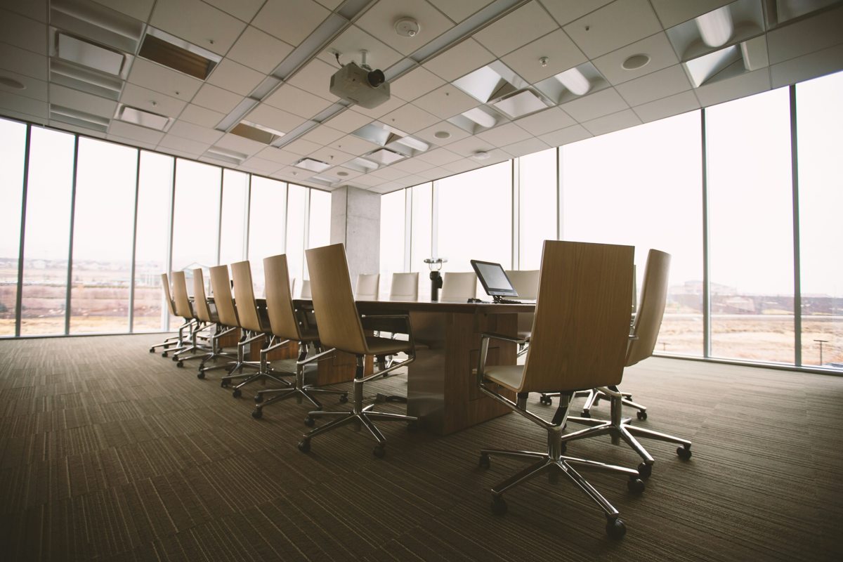 Sunlit conference room with a long table and chairs